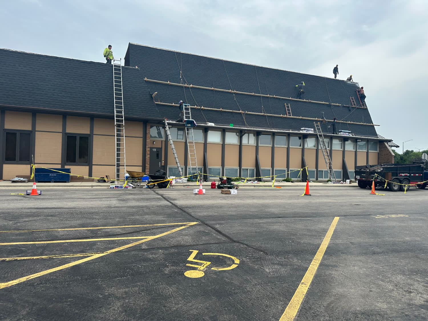 Commercial Mansard Reroof — Crew on staged scaffolding · Large-format commercial roof in Chicago, IL by Avilas Construction